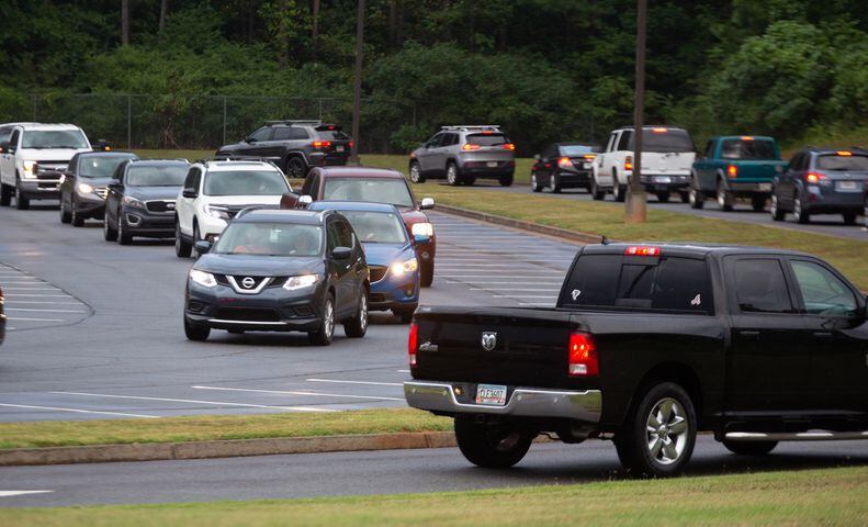Cars line up to drop students off at the entrance of Woodstock Elementary School on the first day of school on August 3, 2020. First Day at School Woodstock Elementary School