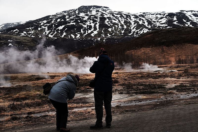REYKJAVIK, ICELAND - APRIL 07:  Tourists visit a geyser Ioutside of Reykjavik on April 7, 2016 in Reykjavik, Iceland. Tourism is one of Iceland's most important sectors with thousands visiting every year to indulge in nature and to see the Northern Lights.   (Photo by Spencer Platt/Getty Images)