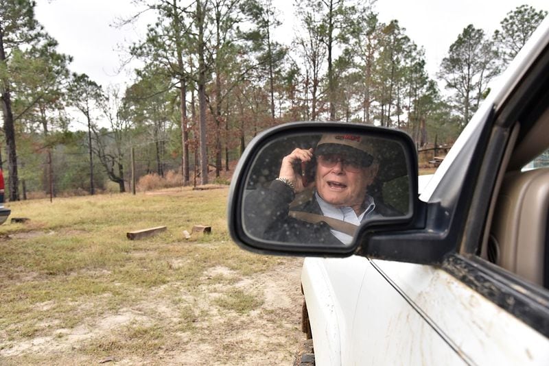 Rex Bullock talks on the phone as he visits his neighbor's farm in Pitts, Ga. In February, Bullock couldn't help but being a little star-struck when he attended a rally for Donald Trump at Valdosta State University and got to shake the man's hand. HYOSUB SHIN / HSHIN@AJC.COM