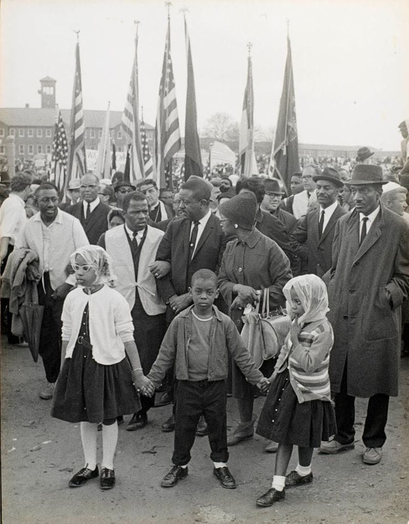 John Lewis, Ralph Abernathy, Sr., Juanita Abernathy during the Selma to Montgomery campaign for Voting Rights in 1965. Lewis would later become a U.S. Congressman decades after surviving a brutal beating during the first attempted Selma to Montgomery march. Juandalynn, Ralph III and Donzaleigh Abernathy hold hands in the foreground. They were some of the many children on the front lines of the Civil Rights Movement. (courtesy of Donzaleigh Abernathy)
