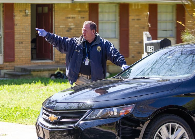 A Clayton County police officer gives directions at the scene of a hostage situation near Jonesboro on Friday morning.
