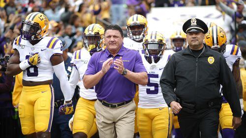 LSU coach Ed Orgeron  leads his team on to the field against Auburn on Oct. 26.