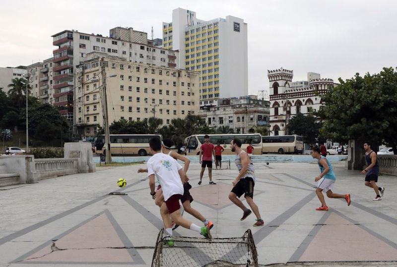 Young Cubans play soccer on a court across from the sea wall on the Straits of Florida in Havana. A national mourning period for the late Cuban leader Fidel Castro has made for quieter streets than usual, though life goes on in other ways. BOB ANDRES /BANDRES@AJC.COM