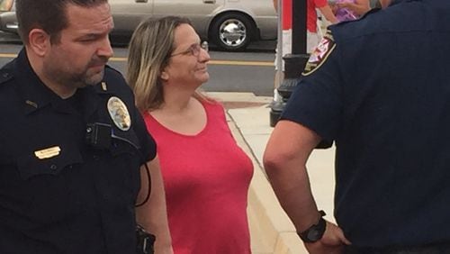 Hapeville City Councilwoman Ruth Barr talks with officers on Aug. 4, 2016, outside City Hall at the city’s night out on crime event. Revenue agents charged Barr with perjury and served an injunction this week that orders her and her firm, B & B Accounting and Tax Service, to stop preparing tax returns.