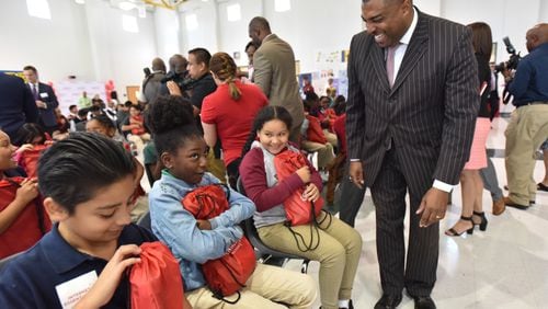 Clayton County superintendent Morcease Beasley congratulates students getting a laptop as part of Internet Essentials program during Internet Essentials Back to School Event at Morrow Middle School in October. Clayton schools showed some gains in elementary and middle school achievement for 2017.