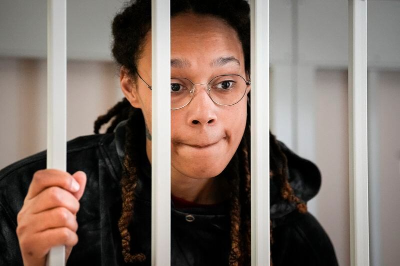 FILE - WNBA star and two-time Olympic gold medalist Brittney Griner speaks to her lawyers from inside a cage in a courtroom in Khimki, outside Moscow, Russia, on July 26, 2022. Griner continues her efforts to settle into a normal routine following her release from a Russian prison 17 months ago. (AP Photo/Alexander Zemlianichenko, Pool, File)