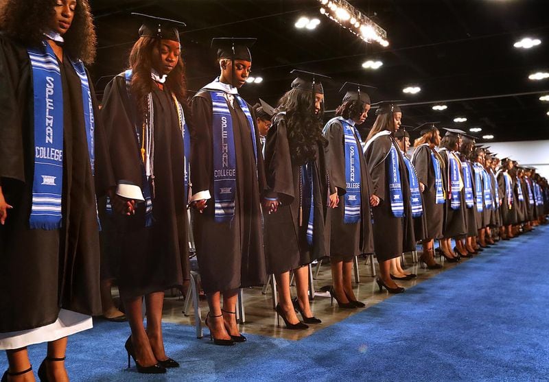 May 21, 2017, College Park: Graduates join hands for an opening prayer during the Spelman College 2017 Commencement Ceremony at the Georgia International Convention Center on Sunday, May 21, 2017, in College Park.     Curtis Compton/ccompton@ajc.com