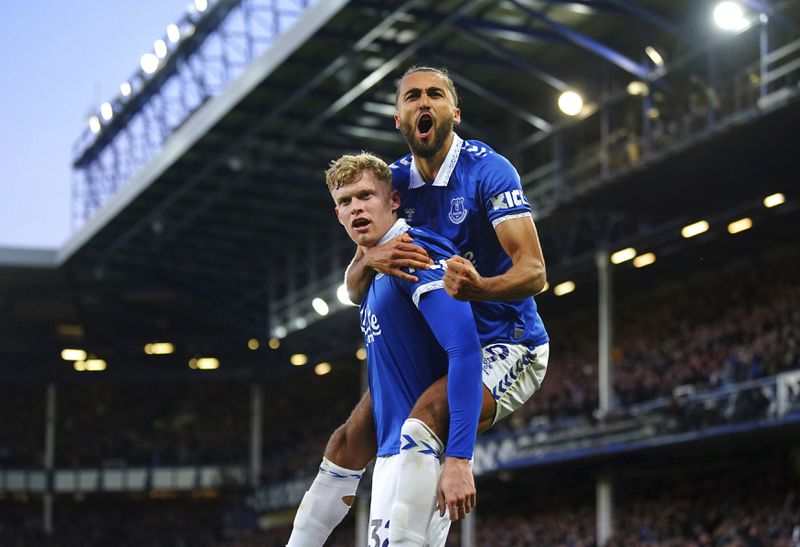 Everton's Jarrad Branthwaite, left, and Dominic Calvert-Lewin celebrate after Branthwaite scored their first goal of the game during a Premier League soccer match against Liverpool, Wednesday, April 24, 2024, at Goodison Park in Liverpool. (Peter Byrne/PA via AP)