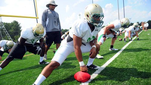 Buford assistant Bryant Appling walks the line of players at the start of football practice Monday, Aug. 1, 2011. Appling made his debut as head coach in 2019, leading the Wolves to a state championship.