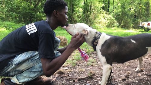James Mathis, 15, of Atlanta bonds with a dog during one of W-Underdogs’ rescue missions. CONTRIBUTED