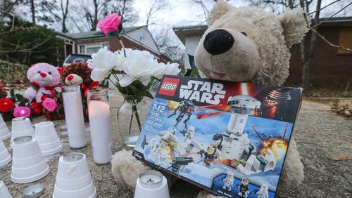 A memorial grew up overnight Tuesday on Jasper Street, near where Logan was killed in a dog attack while on his way to the school bus stop. (AJC file)