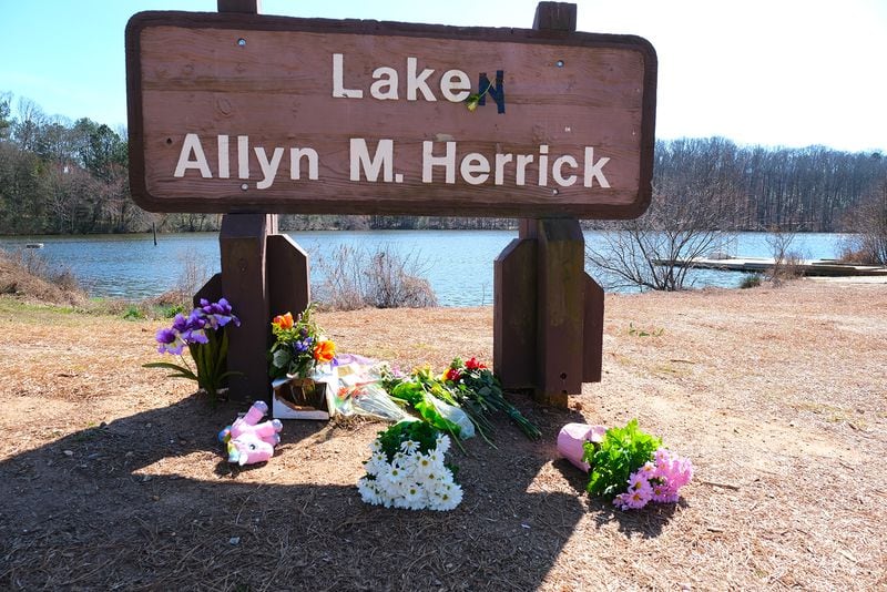 The sign at Lake Herrick has been altered to honor Laken Riley, who was killed last week on the running trails behind the lake in Athens, GA, Monday, February 26, 2024.  (Nell Carroll for The Atlanta Journal-Constitution)