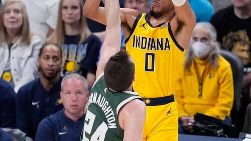 Indiana Pacers' Tyrese Haliburton (0) shoots over Milwaukee Bucks' Pat Connaughton (24) during the first half of Game 4 of the first round NBA playoff basketball series, Sunday, April 28, 2024, in Indianapolis. (AP Photo/Michael Conroy)