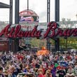 Baseball fans at Truist Park near Atlanta for the Atlanta Braves home opener against the Philadelphia Phillies, on Friday, April 9, 2021. Friday’s home opener offered some prepandemic-like excitement, but even fans who support MLB’s choice to move the All-Star Game and accompanying amateur draft are sad to see it go. (Lynsey Weatherspoon/The New York Times)