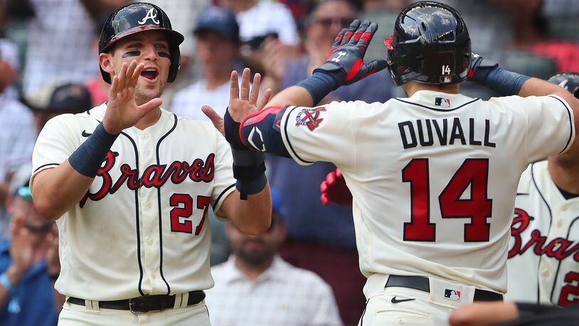 Braves outfielder Adam Duvall is greeted at home by Austin Riley (left) after hitting a two-run homer to take a 5-1 lead over the Washington Nationals during the sixth inning Sunday, Aug. 8, 2021, at Truist Park in Atlanta. (Curtis Compton / Curtis.Compton@ajc.com)