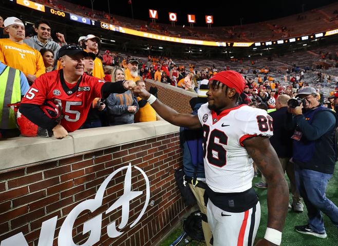 Georgia wide receiver Dillon Bell gives fans a fist bump after defeating Tennessee 38-10 in a NCAA college football game on Saturday, Nov. 18, 2023, in Knoxville.  Curtis Compton for the Atlanta Journal Constitution