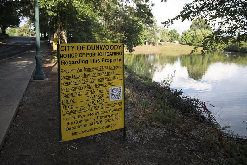  An informative sign is posted near a pond along Ashford Parkway, in Dunwoody. (Alyssa Pointer/alyssa.pointer@ajc.com)