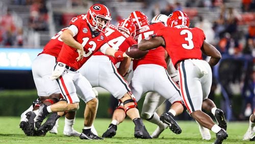 Georgia's offensive line, led by Ben Cleveland (74) creates a space for quarterback Stetson Bennett (13) and running back Zamir White (3) for a run play against Auburn Saturday, Oct. 3, 2020, on Dooley Field at Sanford Stadium in Athens. (Tony Walsh/UGA Sports)