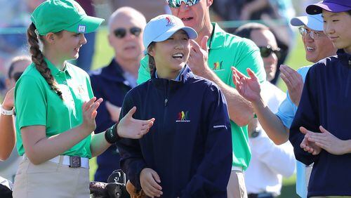Sara Im (center), Duluth, Ga., is all smiles on the 18th green as she is announced the winner of the putting championship and overall championship for 12-13 girls in the Drive Chip & Putt National Finals at Augusta National Golf Club on Sunday. (Curtis Compton/ccompton@ajc.com)