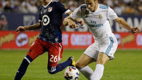 Real Madrid 's Gareth Bale, right, shoots against MLS All-Stars' Miguel Almiron during the second half of the MLS All-Star Game, Wednesday, Aug. 2, 2017, in Chicago. Real Madrid won 4-2 in a penalty shootout. (AP Photo/Nam Y. Huh)