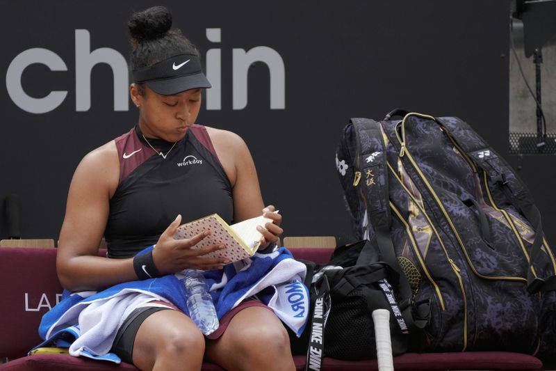 Naomi Osaka, of Japan, pauses at the end of a game during her match against France's Clara Borel at the Italian Open tennis tournament in Rome, Wednesday, May 8, 2024.(AP Photo/Gregorio Borgia)