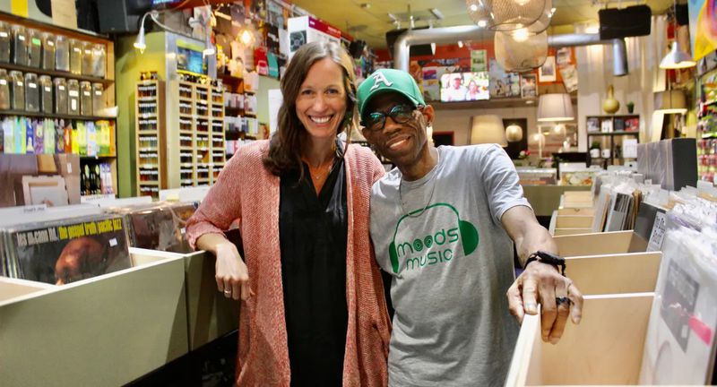 April Stammel, the head of Marketing & Community Engagement for South Downtown Atlanta, poses with Darryl Harris at Moods Music. (Photo Courtesy of Dyana Bagby)
