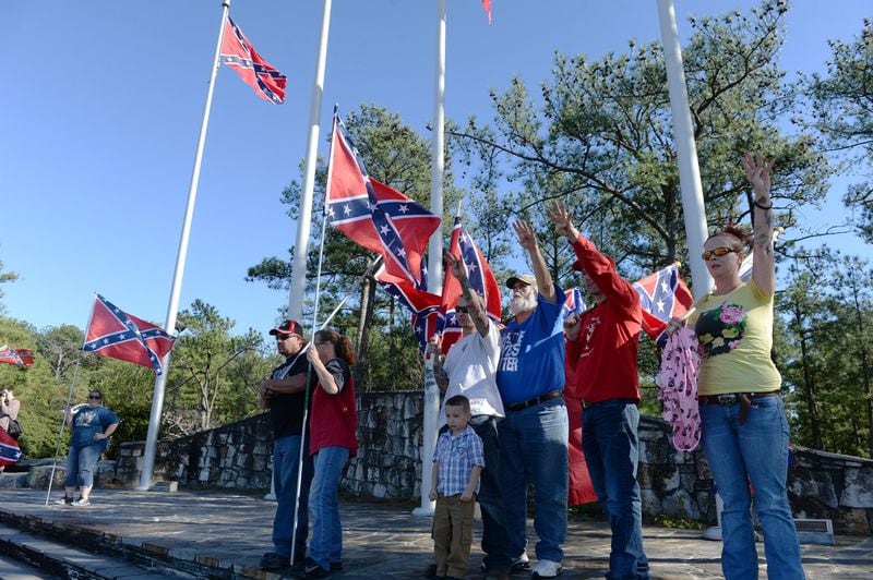 Pro-Confederate flag supporters pose before they head up the mountain on the walk up trail during a protest at Stone Mountain, Saturday, November 14, 2015, after a proposal was made to place a monument on top of it dedicated to Martin Luther King Jr. At noon about 50 protesters and no counter-protesters had arrived. KENT D. JOHNSON/KDJOHNSON@AJC.COM