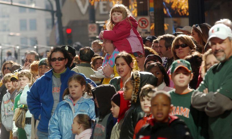 Emily Grondin, 4, sits on her father Robert's shoulders during the Peach Bowl parade in downtown Atlanta Friday, Dec. 30, 2005. They are from Madison, Ala. and say they are big SEC fans who buy tickets every year, regardless of who will be in the Peach Bowl