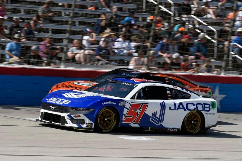 Justin Haley (51) leads Daniel Suarez, rear, out of Turn 4 during a NASCAR Cup Series auto race at Texas Motor Speedway in Fort Worth, Texas, Sunday, April 14, 2024. (AP Photo/Randy Holt)