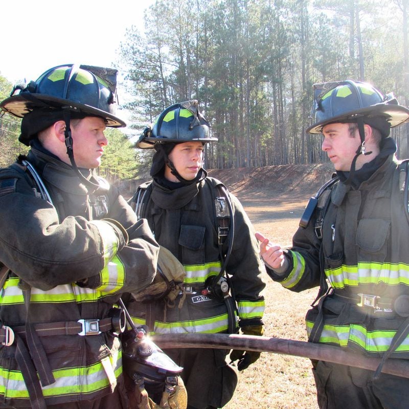 McCormick (center) began working for the Cherokee County fire department in October 2014.