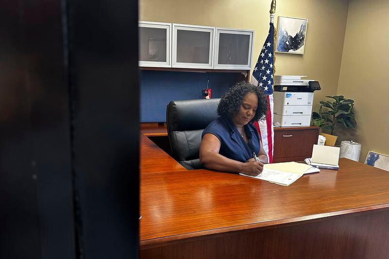 Louisiana Democratic state Rep. Delisha Boyd works at her desk at her office May 3, 2024, in New Orleans. As Boyd faces an uphill battle in Louisiana, as she attempts to advance a bill that would add cases of rape and incest as exceptions to Louisiana's near total abortion ban, the Democrat opens opening up about her mother's harrowing story and how it effected them. (AP Photo/Stephen Smith)