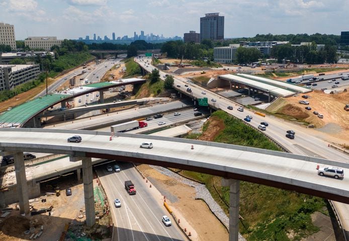 May 27, 2021 Sandy Springs - Aerial photo shows construction site of I-285 interchange at Ga. 400 in Sandy Springs on Tuesday, May 27, 2021. The view is looking south on Georgia 400, with I-285 passing left to right in the image and Atlanta skyline on the horizon. (Hyosub Shin / Hyosub.Shin@ajc.com)