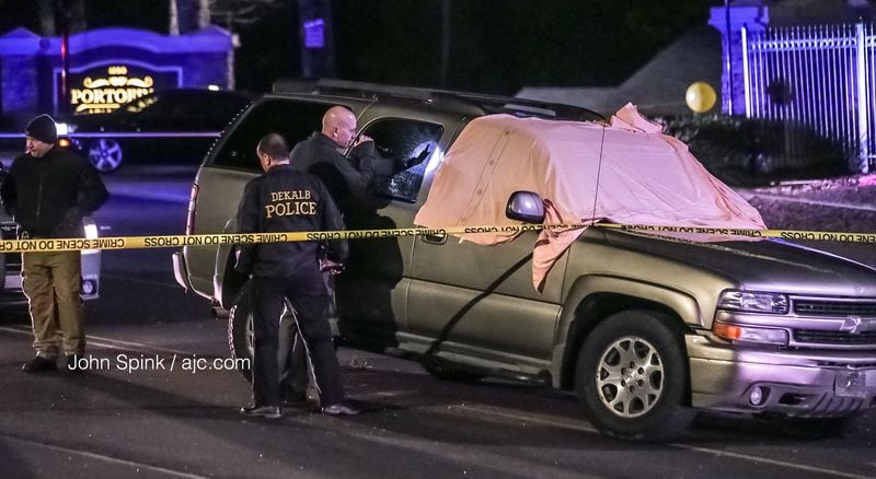 The Tahoe remained in the street surrounded by crime tape. A man was found dead early Tuesday in the SUV. JOHN SPINK / JSPINK@AJC.COM