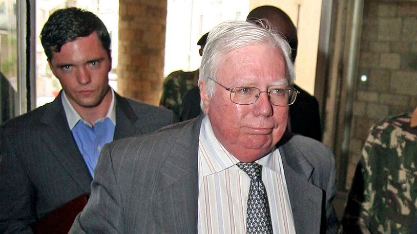 In this Oct. 7, 2008, file photo, Jerome Corsi, right, arrives at the immigration department in Nairobi, Kenya. Corsi, a conservative writer and associate of President Donald Trump confidant Roger Stone says he is in plea talks with special counsel Robert Mueller's team. Jerome Corsi told The Associated Press on Friday, Nov. 23, 2018, that he has been negotiating a potential plea but declined to comment further.