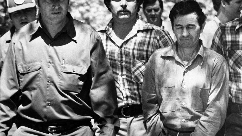 Donald H. “Pee Wee” Gaskins, in handcuffs, right, directed officers to an area in Florence County, South Carolina, April 17, 1978, where human bones were found. Gaskins is related to Elwyn Crocker Sr., charged with starving his children and burying their bodies in South Georgia. (AP Photo)