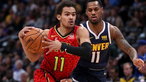Trae Young of the Atlanta Hawks drives to the basket against Monte Morris of the Denver Nuggets.