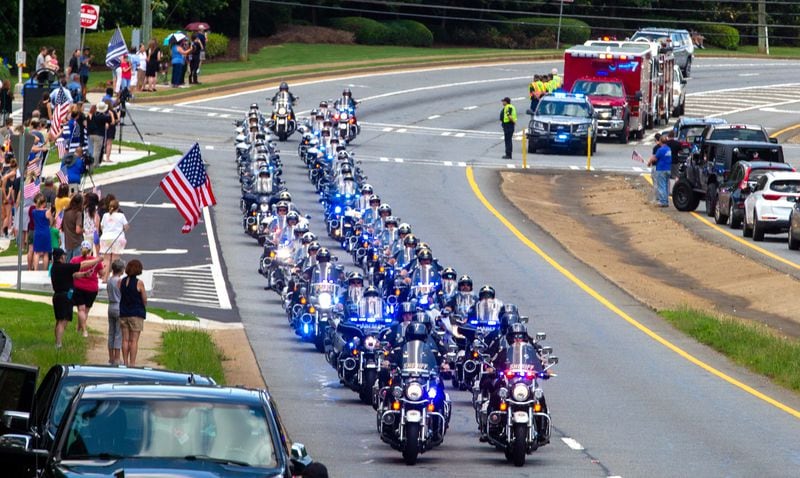 
A police escort drives down Highway 92 in Woodstock  after the funeral of Joe Burson at the First Baptist Church of Woodstock on June 21, 2021STEVE SCHAEFER FOR THE ATLANTA JOURNAL-CONSTITUTION