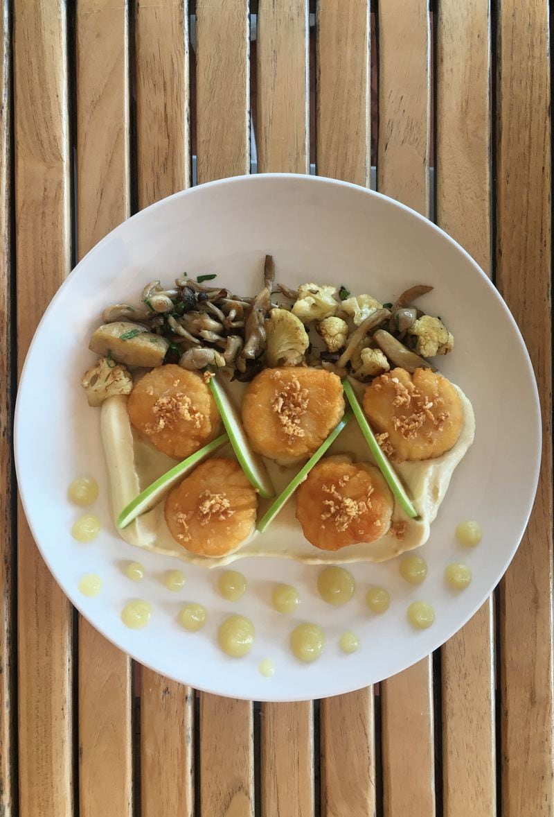 The sauteed scallops entree offers a play on textures and flavors, with tart granny smith apple slices and purée. Credit: Foundation Social Eatery Foundation