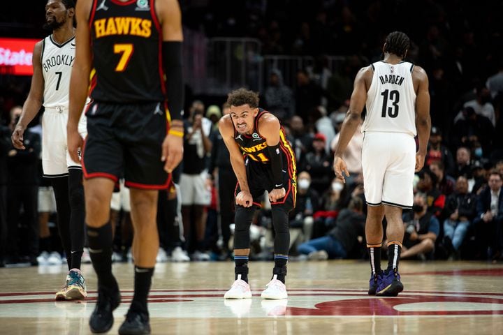 The Hawks' Trae Young (11) grimaces during a game between the Atlanta Hawks and the Brooklyn Nets at State Farm Arena in Atlanta, GA., on Friday, December 10, 2021. The Nets won 113-105. (Photo/ Jenn Finch)