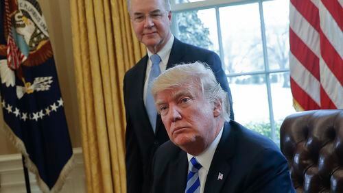FILE - In this March 24, 2017 file photo, President Donald Trump with Health and Human Services Secretary Tom Price are seen in the Oval Office of the White House in Washington. Congress is launching a wide-ranging examination of air travel by high-ranking Trump administration officials. The House Oversight and Government Reform committee is following up on reports that health secretary Tom Price used pricey charters when cheaper commercial flights would have done.  (AP Photo/Pablo Martinez Monsivais, File)