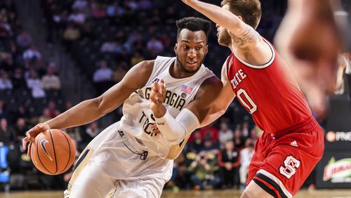 Georgia Tech guard Josh Okogie, left, drives to the basket as North Carolina State guard Braxton Beverly defends in the first half of an NCAA college basketball game, in Atlanta, Thursday, March 1, 2018. (AP Photo/Danny Karnik)