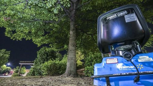 A Walmart electric cart sits idle near the tree where a woman’s body was found hanging near a Walmart at 6149 Old National Highway in South Fulton early Monday May, 14, 2018. A police investigation determined the woman killed herself. South Fulton police continue to investigate the incident. JOHN SPINK/JSPINK@AJC.COM