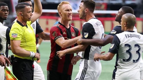 June 2, 2018 Atlanta: An official pulls a red card on Philadelphia Union midfielder Haris Medunjanin as Atlanta United midfielder Jeff Larentowicz holds him back while he argues a call during the first half in a MLS soccer match on Saturday, June 2, 2018, in Atlanta. Two Philadelphia Union players drew red cards on the play and were ejected from the game.  Curtis Compton/ccompton@ajc.com