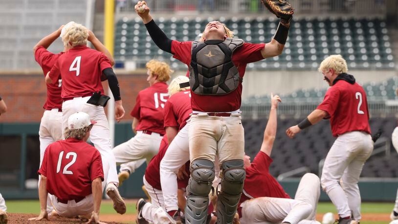 Lowndes’ catcher Nate Slaughter and teammates celebrate their 5-2 win against Parkview in game two to win the GHSA baseball 7A state championship at Truist Park, Wednesday, May 17, 2023, in Atlanta. Lowndes won the GHSA baseball 7A state championship series 2-0. (Jason Getz / Jason.Getz@ajc.com)