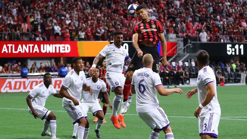 Atlanta United defender Miles Robinson tries to head a corner kick into the net over a host of Orlando City defenders during the first half Sunday, May 12, 2019, at Mercedes-Benz Stadium in Atlanta.