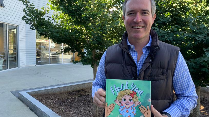 Craig Lucie, the former WSB-TV anchor, is now in public relations but also decided to write a children's book "Hold You." RODNEY HO/rho@ajc.com