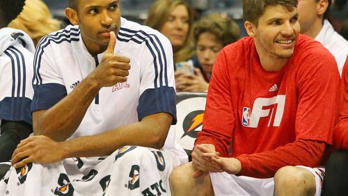 012115 ATLANTA: Al Horford gives some fans a thumbs up in the final minute of a 110-91 victory over the Pacers for the Hawks 14th consecutive victory to tie a franchise record in a basketball game on Wednesday, Jan. 21, 2015, in Atlanta. At right is Kyle Korver cracking a smile. Curtis Compton / ccompton@ajc.com