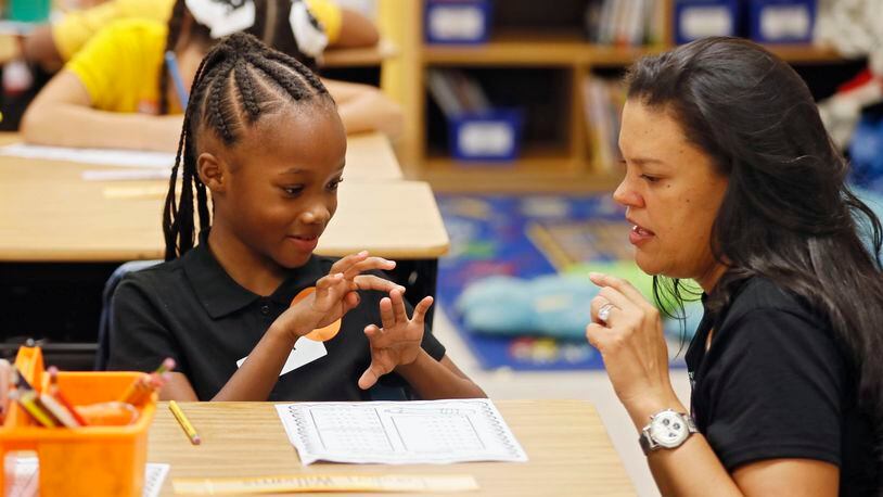 8/1/18 - Atlanta -  Superintendent Meria Carstarphen, helps London Williams with her math assignment in Hannah Reisman's class.   It was the first day of school at Peyton Forest Elementary school, which is  celebrating its 50th anniversary.   Teachers and staff welcomed the kids with a circus theme.  BOB ANDRES  /BANDRES@AJC.COM