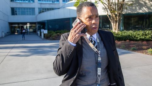 Gwinnett’s solicitor general, Brian Whiteside, takes phone call while leaving the Gwinnett Justice and Administration Center. (Photo by Phil Skinner) AJC FILE PHOTO