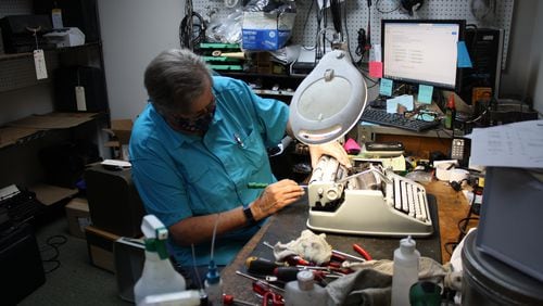 Mary Ranson’s workstation includes a variety of solvents and tools that keep typewriters of past decades in motion. Ranson is making repairs to the carriage on a Hermes 3000 manual typewriter.
